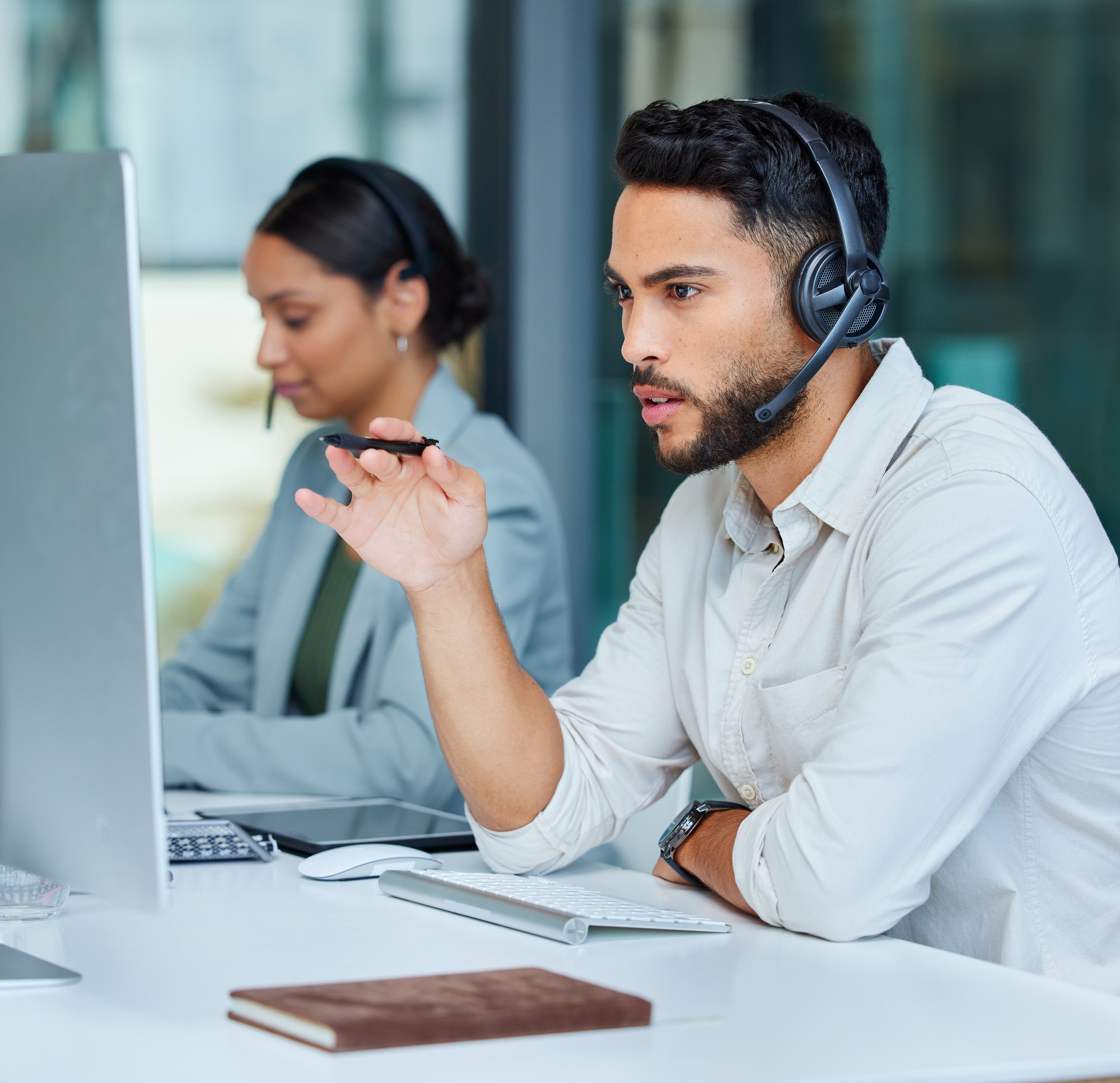 Shot of two businesspeople working in a call center